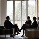 Designers consult with client in a living room